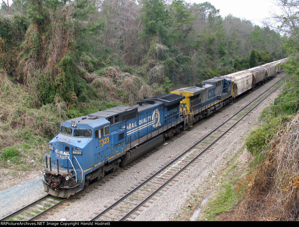 CSX 7323 leads a grain train held at Rice Street